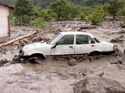 A car is seen after being pulled down by the flooded Mocoties River in the state of Merida, 800 km west of Caracas, February 12, 2005. Rescue workers are struggling to reach remote villages in Venezuela's Andean mountains cut off by torrential rains and landslides that have killed more than 40 people in nearly a week. Local authorities said on Saturday they had found at least 25 bodies in Santa Cruz de Mora in the state of Merida and feared many more were dead after rains flooded rivers and sent scores of mud slides tumbling into homes, roads and bridges. REUTERS/Str REUTERS 