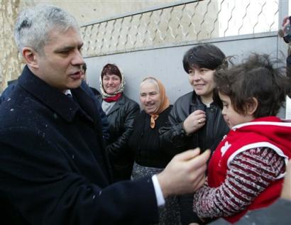 Serbian President Boris Tadic shakes hands with Serb villagers in Silovo, eastern Kosovo, where he arrived for a two-day tour starting Sunday, Feb 13, 2004. Tadic is to tour several Serb enclaves in Kosovo and meet with the province's U.N. administrators. (AP Photo/Darko Vojinovic) 