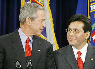 US President George W. Bush (L) and Attorney General Alberto Gonzales look at each other after Gonzales was sworn-in by Supreme Court Justice Sandra Day O'Connor during an installation ceremony at the US Department of Justice in Washington, DC. [AFP]