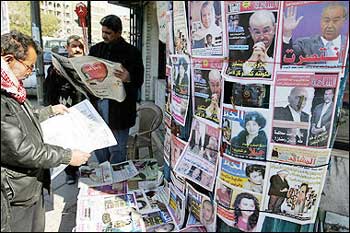 Iraqis read the morning papers in central Baghdad. Iraq's press welcomed the election results which delivered victory to the long-oppressed Shiite majority, but questioned what the future held for the nation's fledgling democracy and efforts to end a deadly Sunni insurgency. [AFP]
