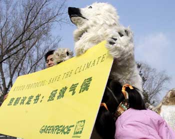 A little girl curiously checks a polar bear specimen displayed by university students to celebrate the Kyoto Protocol in a Beijing park February 16, 2005. The global pact, intended to help check the emission of greenhouse gases and save the environment, comes into force on Wednesday after having been ratified by 140 countries. China signed the pact in May 1998 and ratified it in August 2002. Beijing students organized these activities to mark the great day in the global environmental protection history. [newsphoto]