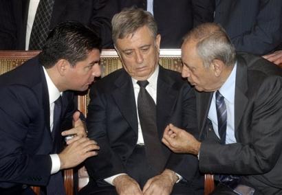 Syrian Vice President Abdul-Halim Khaddam, center, listens to Bahaa Hariri, son of the slain former prime minister, left, and Lebanese parliament speaker Nabih Berri, at a memorial service for former Lebanese Prime Minister Rafik Hariri in Beirut, Lebanon Tuesday, Feb. 15, 2005. Syria is the main power broker in Lebanon and Hariri, who served in office 10 of the last 14 years, began moving in recent months closer to the opposition, which has waged an unprecedented political campaign to bring Damascus to withdraw its army from Lebanon. The United States called the attack 'a terrible reminder' that Lebanon still must shake free of occupation by Syria.(AP Photo)