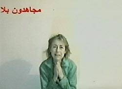 A frame grab taken from a video tape released by insurgents February 16, 2005, shows Giuliana Sgrena, an Italian journalist kidnapped in Iraq, begging for her life and appealing for foreign troops to withdraw from Iraq. [Reuters]