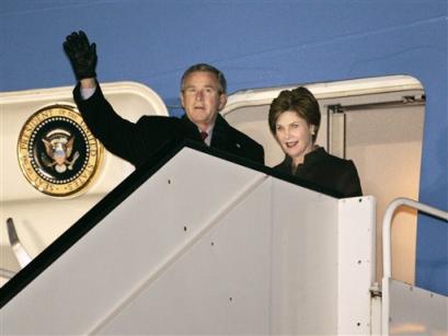 U.S. President George W. Bush and first lady Laura Bush arrive at Brussels National Airport in Brussels, Belgium, Sunday, Feb. 20, 2005. Bush will attend a meeting with NATO and European Union leaders and travel to Germany and Slovakia during his five-day European tour. [AP]