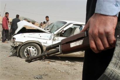An Iraqi policeman stands by the scene of a car shot at by unidentified foreign security forces which resulted in the death of a woman and injured another person traveling with her in the car in the Amiriyah area of Baghdad, Iraq Sunday, Feb. 20, 2005. [AP]