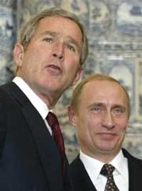 U.S. President Bush and Russian President Vladimir Putin talk during a joint news conference at Catherine Palace in Pushkin, Russia, in this Nov. 22, 2002 file photo. President Bush is urging Russian President Vladimir Putin to reverse Moscow's recent retreat from democratic reforms, while seeking to refresh his 'close relationship' with his Russian counterpart. [AP] 