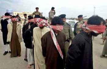 A group of handcuffed and blindfolded foreign detainees are guided by Iraqi Army soldiers following their arrest in the holy city of Najaf, February 25, 2005. The insurgency in Iraq is not likely to be put down in a year or even two since history shows such uprisings can last a decade or more, the United States' top military commander said on February 25, 2005. Air Force Gen. Richard Myers said that in the past century, insurgencies around the world have lasted anywhere from seven to 12 years, making a quick fix to the problem in Iraq unlikely. [Reuters]