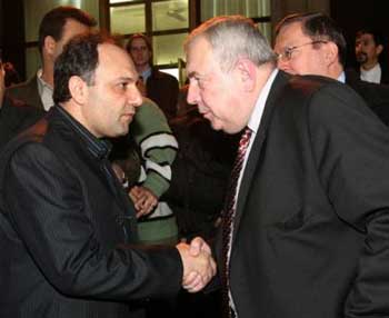 Russia's Federal Atomic Energy Agency head Alexander Rumyantsev, right, shakes hands with Vice-President of the Atomic Energy Organization of Iran, Mohammad Saeedi, at Mehrabad airport in Tehran Friday Feb. 25, 2005. Rumyantsev, arrived in Tehran to sign a key deal to supply Iran with enriched fuel for its first nuclear reactor on condition that the spent fuel is returned. [AP]