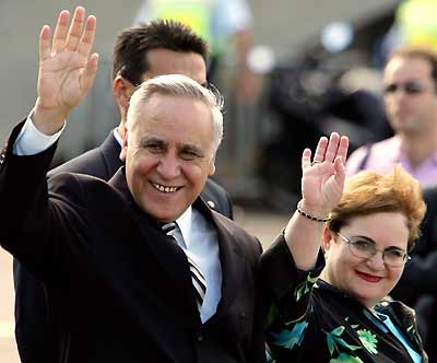 Israel President Moshe Katsav and his wife Gila wave as they board a boat for a cruise on Sydney Harbour February 28, 2005. Katsav will meet Australian Prime Minister John Howard and members of the Jewish communities in Sydney and Canberra during his one week stay in Australia. [Reuters]
