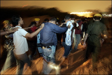 Migrant workers are led to have their documents inspected during an immigration raid in Kuala Lumpur. At least 100 Filipinos who illegally entered Malaysia have been arrested in a massive immigration crackdown begun by Kuala Lumpur this week(AFP/Jimin Lai) 