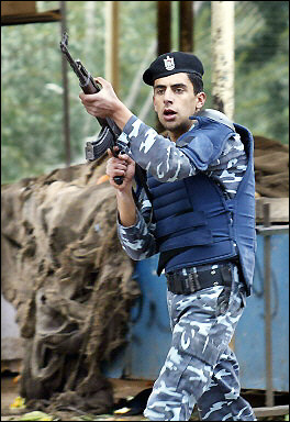 A Palestinian policeman fires into the air during clashes between Fatah militants and policemen in the northern West Bank town of Nablus. [AFP]