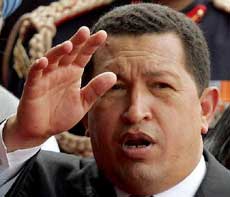 Venezuela President Hugo Chavez waves to reporters in New Delhi March 4, 2005. He said said on Saturday he had evidence that the United States was planning to assassinate him, an accusation that a U.S. official quickly denied.