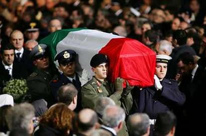 The coffin of slain Italian intelligence officer Nicola Calipari is carried by members of Italy's armed forces into Rome's Saint Maria degli Angeli church during a state funeral March 7, 2005. Italy paid homage to the intelligence officer killed in Iraq by U.S. forces, giving him a full state funeral that was tinged with anger over how he was gunned down while protecting a freed Italian hostage. [Reuters]