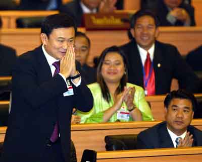 Thailand's Prime Minister Thaksin Shinawatra gives a traditional Thai greeting at Parliament in Bangkok March 9, 2005. Thai Parliament approved Thaksin for a second four-year term, following the former telecommunications tycoon's landslide victory at the polls last month. [Reuters]