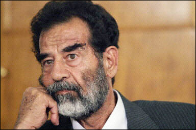 Saddam Hussein listens in a courtroom in Baghdad. [AFP/File]