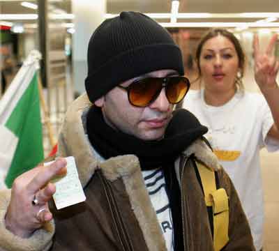 An Iranian passenger displays his boarding card at Zaventem airport in Brussels March 11, 2005. A group of Iranian monarchists refused to disembark from a Lufthansa aircraft at Brussels airport in a protest against the Islamic government in Tehran. [Reuters]