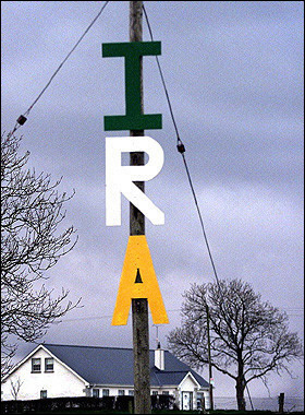 A telegraph pole with a sign supporting the Irish Republican Army in south Armagh. MPs stripped their four Sinn Fein colleagues of their annual allowances after the party's military wing, the IRA, was blamed for crimes in Northern Ireland. [AFP/File]