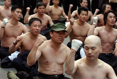 Former South Korean intelligent agents with half-naked to show their emotion, shout slogans during a rally against Japan's sovereignty claims over South Korea (news - web sites)'s Dokdo islets in front of the Japanese Embassy in Seoul Tuesday, March 15, 2005. The volcanic islets, located about 90 kilometers (55 miles) east of South Korea's Ullung Island and known as Dokdo in Korea and Takeshima in Japan, have been a source of diplomatic friction with Tokyo for years. (AP Photo/ Lee Jin-man) 