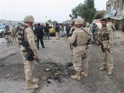 U.S. soldiers and Afghan officials inspect the site of explosion in Kandahar, Afghanistan on Thursday, March 17, 2005. At least five people were killed and 32 injured in an explosion Thursday in central Kandahar, southwestern Afghanistan, Afghan Islamic Press reported. [AP]