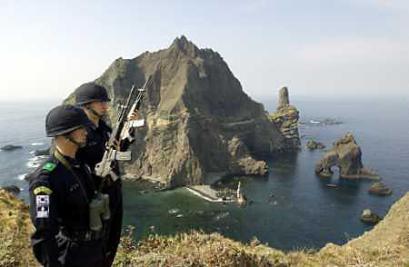 South Korean police officers stand guard on Tokto islands, about 55 miles east of South Korea's Ullung Island on March 16, 2005. Ties between Japan and South Korea have been seriously hurt by a territorial dispute over desolate islands that lie in gas-rich waters, South Korean officials said. [Reuters]