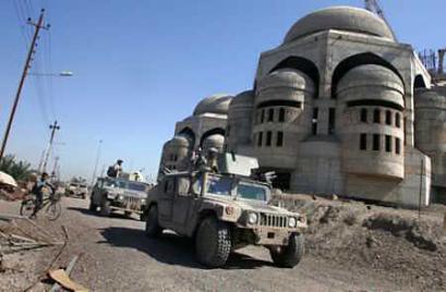 Troops from the U.S. Army 10th Mountain Division patrol the grounds outside the uncompleted Grand Mosque in Baghdad on March 17, 2005. The Army expects to begin cutting troop levels in Iraq (news - web sites) as soon as this year, a move that would reduce the level of U.S. forces there to below 138,000, an Army general said on Thursday. 'I think for the next force rotation, we'll start seeing that (the) force rotation coming in will be smaller than the force that's in there,' said Gen. Richard Cody, the Army's vice chief of staff. (Bob Strong/Reuters) 