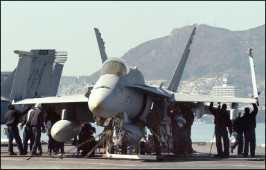 US sailors check an F-18 Hornet strike fighter on the flight deck of the USS Kitty Hawk aircraft carrier. The USS Kitty Hawk carrier and battle group arrived in Busan to take part in joint military exercises with the South Korean armed forces. North Korea (news - web sites) said the exercises were aimed at making a preemptive strike and justified the bolstering of its 'self-defensive nuclear arsenal'(AFP/File) 