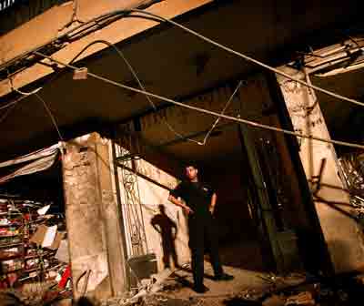 A Lebanese rescue worker stands at the entrance of a building damaged by a bomb blast in eastern Beirut March 19, 2005. A car bomb exploded in a mainly Christian eastern suburb of Lebanon's capital early on Saturday, wounding six people. [Reuters]