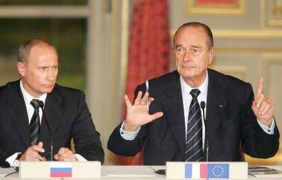 French President Jacques Chirac (R) gestures as he sits by Russian President Vladimir Putin (L) during a joint press conference after an informal meeting at the Elysee Palace in Paris March 18, 2005. Chirac met with leaders of Spain, Germany and Russia for informal talks. [Reuters]