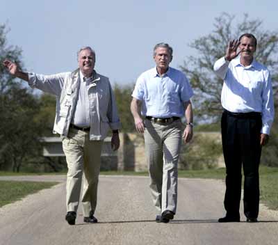Canadian Prime Minister Paul Martin (L) and Mexican President Vicente Fox (R) wave to the press as U.S. President George W. Bush gives them a tour of his ranch following lunch in Crawford, Texas, March 23, 2005. President Bush and the leaders of Canada and Mexico earlier announced Wednesday a broad plan to strengthen economic and security ties among the three countries. [Reuters]
