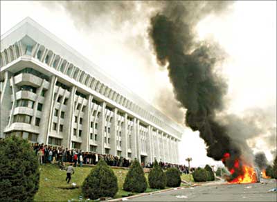 Black smoke billows into the air outside the presidential residence in Bishkek yesterday. Kyrgyzstan's opposition seized the main government building in the capital. [Reuters]