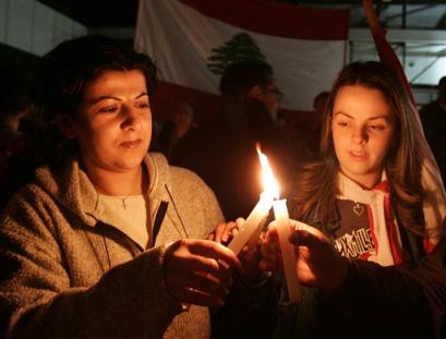 Two Lebanese women light candles during a candle light vigil at the bomb site at the Alta Vista shopping center on the Kaslik stretch near Jounieh, the main Christian port city 15 kilometers (about 10 miles) north of Beirut, Lebanon, Thursday March 24, 2005.. U.N. Secretary General Kofi Annan (news - web sites) is expected to soon announce the report of a U.N. fact-finding team that inspected the site of Hariri's assassination. But Annan announced Wednesday that a fresh investigation may be needed.(AP Photo/Marwan Assaf) 