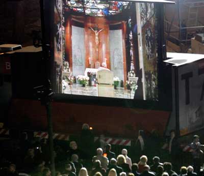 Pope John Paul II appears video-linked from his apartments at the Vatican at the start of the traditional Via Crucis (Way of the Cross ) Good Friday service at Rome's ancient Colosseum, March 25, 2005. [Reuters]