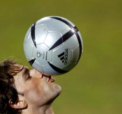 Netherlands soccer team star and Manchester United striker Ruud van Nistelrooy kisses a ball during an official training session at Giulesti stadium in Bucharest, March 25, 2005. Netherlands will face Romania in a World Cup European zone Group one qualifier on March 26. [Reuters]