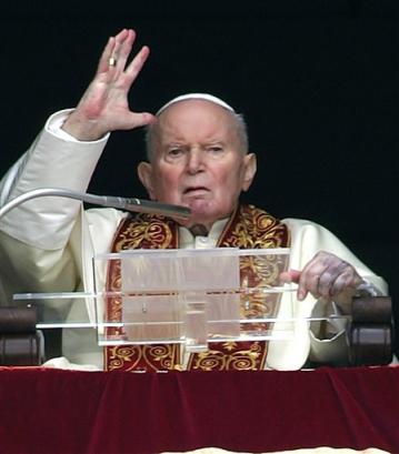 Pope John Paul II delivers an Easter Sunday blessing from his studio's window overlooking St. Peter's Square at the Vatican, Sunday, March 27, 2005. For the first time since John Paul's papacy began in 1978, Easter Sunday Mass at the Vatican was celebrated without the pope as he continued his convalescence following two recent hospitalizations for breathing crises. For years, John Paul also has suffered from Parkinson's disease. [AP]