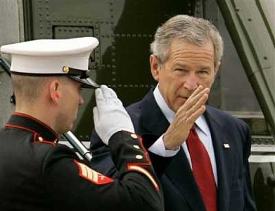 US President Bush returns a salute as he steps off of his helicopter, Marine One, as he and first lady Laura Bush arrive for Easter worship services at Ft. Hood, Texas, about fifty miles from their ranch in Crawford, Sunday, March 27, 2005. The president will return to Washington on Monday. [AP]
