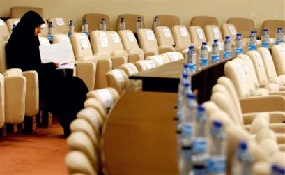 A female member sits alone before the start of Iraq's National Assembly session in Baghdad, Iraq, Tuesday, March 29, 2005. Shouting from their seats, lawmakers failed to agree on a parliament speaker during the National Assembly meeting Tuesday, with wrangling over bringing in Sunni Arabs. (AP Photo/Wathiq Khuzaie, Pool) 