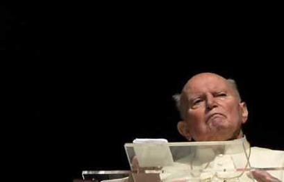 Pope John Paul II looks on as he appears from the window of his private apartments at the Vatican March 30, 2005. The Pope failed in his efforts to talk in public for the second time in four days, again fuelling widespread concern about his ability to recover from recent throat surgery. (Max Rossi/Reuters) 