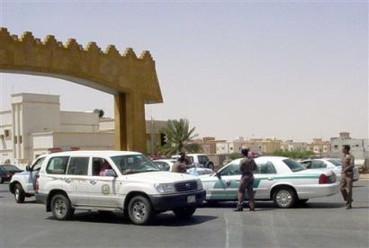 Saudi policemen check vehicles at a checkpoint in ar-Rass, 220 miles (355 kilometers) northwest of the capital, Riyadh, Saudi Arabia Monday, April 4, 2005 where seven suspected al-Qaida militants were killed in a shootout with Saudi security forces . (AP Photo/STR) 