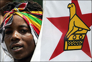 A supporter of Robert Mugabe's ZANU PF ruling party carries the Zimbabwean flag during Mugabe's last electoral rally in Harare on the eve of parliamentary elections. The United States stuck to its assessment that Zimbabwe's parliamentary elections last week were neither free nor fair despite an endorsement by the African state's neighbors.(AFP/File/Alexander Joe)