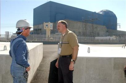Charles S. Williamson, Exelon Generation Company security manager, right, talks to a worker next to rows of 55,000-pound concrete blocks, that act as barriers to vehicular attack at the nuclear Clinton Power Station in Clinton, Ill. , in this Oct. 25, 2004 file photo. A largely classified 130-page National Academy of Sciences report compiled by panel of nuclear experts and released Wednesday, April 6, 2005, called for for a plant-by-plant examination of the fuel storage pools at nuclear power reactors, declaring the material may be vulnerable to a potential terrorist attack and deadly release of radiation. (AP Photo/Herald & Review, Carlos T. Miranda) 