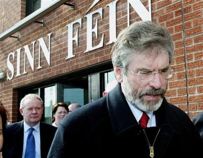 Sinn Fein President Gerry Adams, right, and party colleague Martin McGuinness, left, arrive for a press conference in West Belfast, Northern Ireland, Wednesday, April, 6, 2005. Adams appealed to Irish Republican Army members Wednesday to leave their 35-year 'armed struggle' in Northern Ireland behind. Adams, a reputed IRA commander since the mid-1970s, didn't directly call for the outlawed organization to disarm fully and disband, as the British, Irish and American governments have repeatedly demanded. But he did call for IRA members to begin internal discussions immediately about giving their exclusive support to Sinn Fein, the major Catholic-backed party in this British territory. (AP Photo / Peter Morrison) 