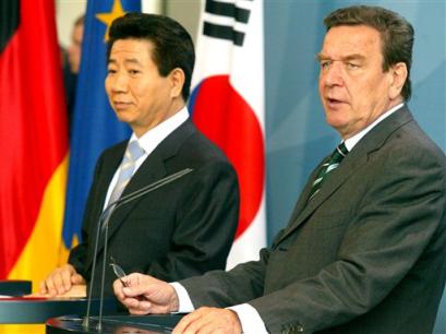 President of South Korea Roh Moo-hyun, left, and German Chancellor Gerhard Schroeder, right, brief the media after their talks in the Chancellery in Berlin, Wednesday, April 13, 2005. (AP