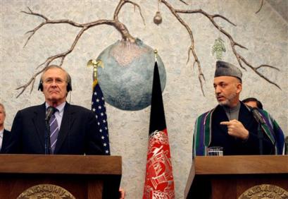 U.S. Secretary of Defense Donald Rumsfeld, left, and Afghan President Hamid Karzai listen questions during a press conference in Kabul, Afghanistan, Wednesday, April 13, 2005. (AP Photo/Tomas Munita) 