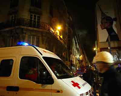 An ambulance is parked near a Parisian hotel where a fire had started in earlier in the morning in Paris April 15, 2005. [Reuters]