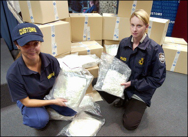 Australian Federal Police and customs agents display some of five million seized ecstasy tablets. Australian authorities arrested four men in what they said was the biggest ever haul of the party drug anywhere in the world(AFP