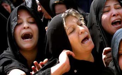 Women grieve during the funeral of Iraqi Army Major-General Adnan Midhish Kharagoli, an adviser to the Defense Minister, after he was killed along with his nephew when 10 gunmen burst into his home in Baghdad April 19, 2005. Guerrilla attacks on Iraqi forces in Baghdad and in a town west of the capital killed at least eight people and wounded 25 on Tuesday, police and hospital officials said. (Ali Jasim/Reuters) 