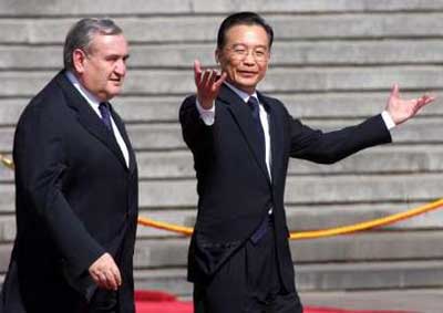 Chinese Premier Wen Jiabao gestures during a welcome ceremony for French Prime Minister Jean-Pierre Raffarin (L) at the Great Hall of the People in Beijing April 21, 2005. Raffarin is on a three-day visit to China.
