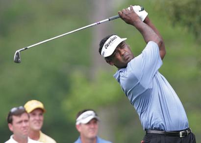 Defending champion Vijay Singh of Fiji watches his tee shot on the eighth hole during the first round of the Houston Open, Thursday, April 21, 2005, in Humble, Texas. Singh tied the course record with an 8-under-par 64. (AP