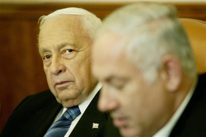 Israeli Prime Minister Ariel Sharon, pictured during a meeting at his office in Jerusalem,Thursday, April 21, 2005. Meanwhile, a proposal to delay the Gaza withdrawal gained momentum after Defense Minister Shaul Mofaz recommended that the operation be postponed by three weeks, until August 15. At right is Israeli finance minister Benjamin Netanyahu. (AP