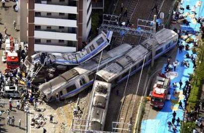 Aerial view of a derailed commuter train that smashed into an apartment building in Amagasaki, western Japan April 25, 2005, killing two people and injuring many others. Up to 60 people have been hurt and 20 taken to hospital, public broadcaster NHK reported.